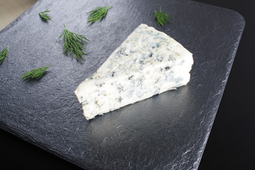 blue cheeseon a dark stone background