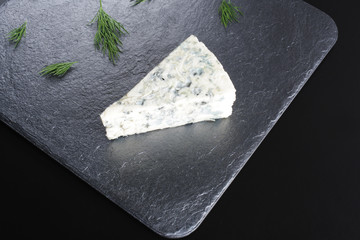 blue cheeseon a dark stone background