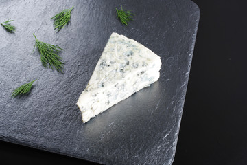 blue cheeseon a dark stone background