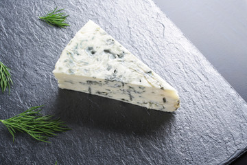 blue cheeseon a dark stone background