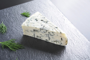 blue cheeseon a dark stone background