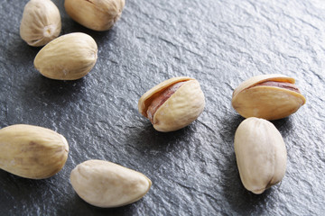 pistachioson a dark stone background