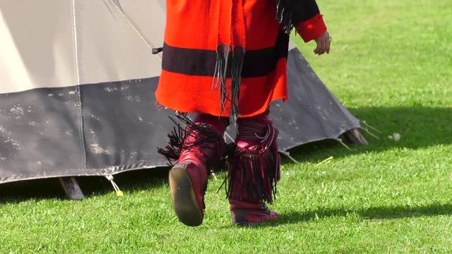 indiginous native indian walking in traditional dress boots slow motion