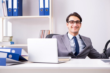 Businessman looking after newborn baby in office