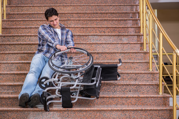 Disabled man on wheelchair having trouble with stairs
