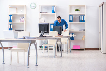 Handsome businessman employee sitting at his desk in office