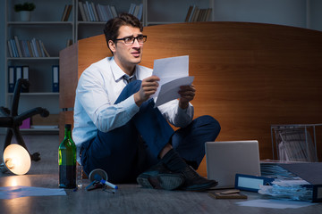 Stressed businessman working overtime in depression