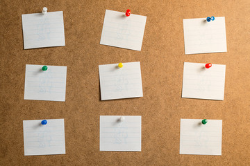 nine white stickers for taking notes on a cardboard background