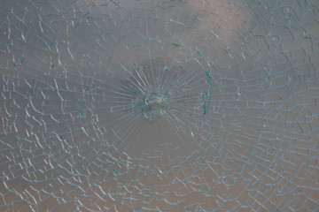 Cracked glass of milk color. Damaged glass structure in the terrace in the amphitheater.