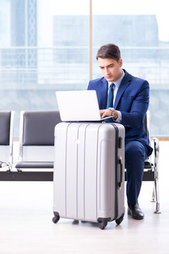 Businessman waiting at the airport for his plane in business cla