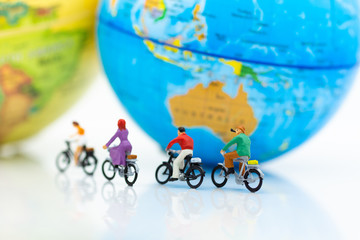 Miniature people : People group riding bicycle with world map. Image use for sport, travel and business concept.