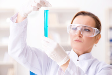 Woman chemist working in hospital clinic lab