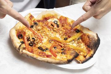 Man pointing at just made homemade pizza