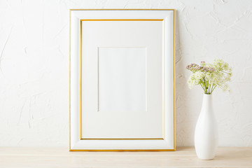 Gold decorated frame mockup with white and pink wildflowers