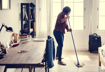 Black woman cleaning room