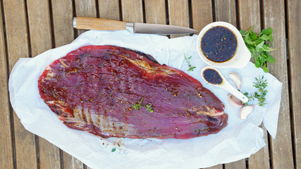raw flank steak in the marinade. style vintage. top view. selective focus