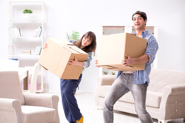 Young family moving in to new apartment after paying off mortgag