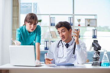 Fototapeta premium Doctor angry at his assistant due to medical error