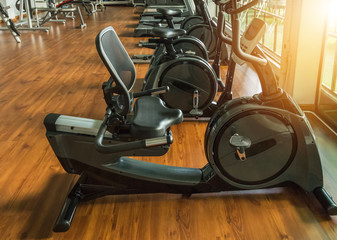 rows of stationary bikes and treadmills equipment  health exercise for bodybuilding in gym modern fitness center room