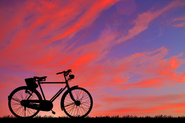 silhouette vintage bike on sunrise.
