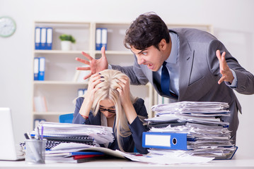 Angry irate boss yelling and shouting at his secretary employee