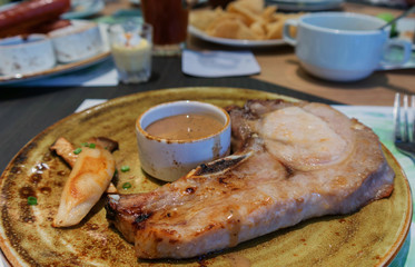 grilled pork chop on brown plate