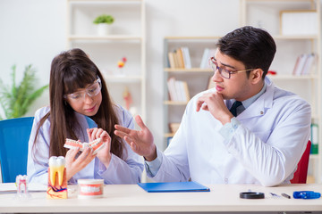 Dentist explaining student tooth structure