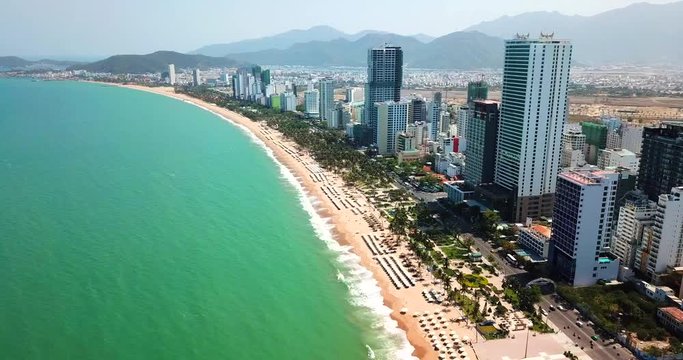 AERIAL 4K:  view on the resort sand beach line in Nha Trang city- Central Vietnam