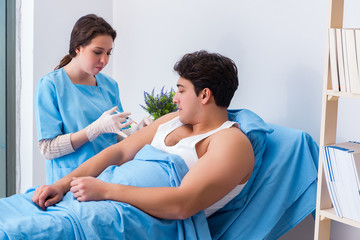 Doctor doing medical injection in hospital room