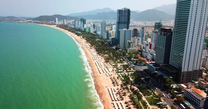 AERIAL 4K:  view on the resort sand beach line in Nha Trang city- Central Vietnam