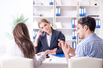 Young family filing divorce papers with lawyer