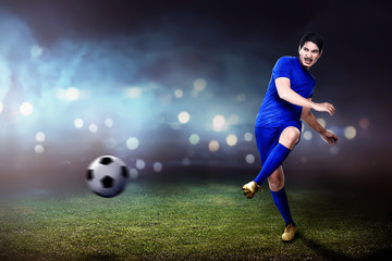 Obraz na płótnie Canvas Young asian footballer man kicking the ball