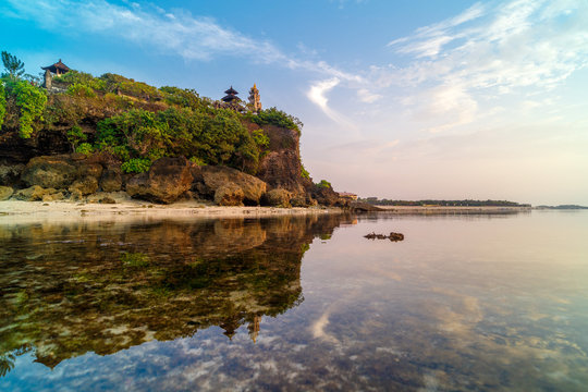 Geger beach and Pura Geger in Nusa Dua, Bali, Indonesia. Tradition Balian temple on cliffe over water
