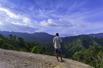 Fototapeta premium a man standing on hilltop look around the valley