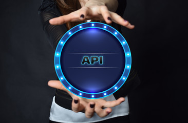 In the hands of a businessman, a neon circle with the inscription:API