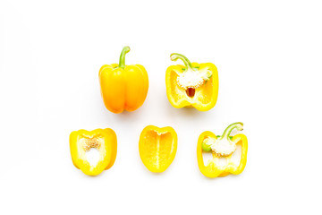 Layout of yellow sweet bell pepper slices on white background top view pattern