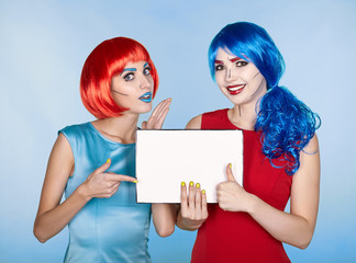 Females with paper in hands. Portrait of young women in comic pop art make-up style
