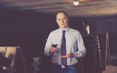 Winemaker offering red wine for tasting