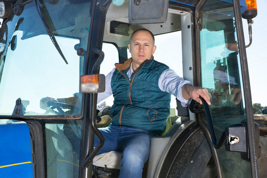 Man sitting in tractor cab