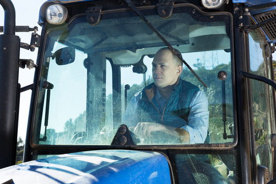 Man sitting in tractor cab