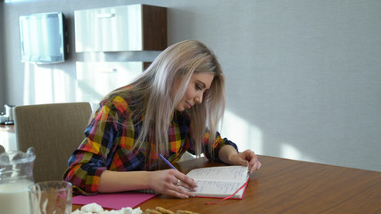 education knowledge studying. young girl college or university student doing homework. writing in the notebook