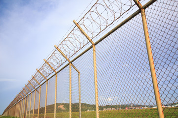 Metal fence wire, War and sky in the background in Phuket Thailand