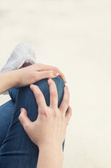 Pain in the knee. Pain in the knee, hands on the knee.