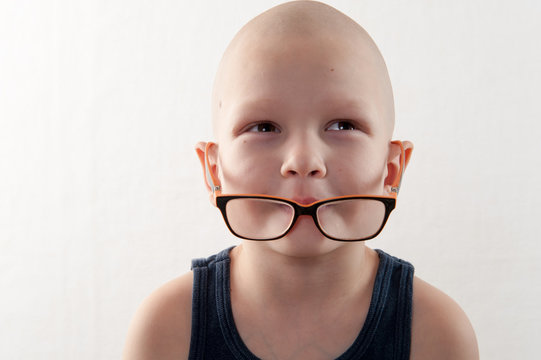 bald, charming child plays with his older brother's glasses