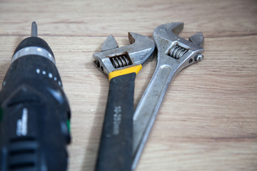 spanners and screwdriver on wooden table
