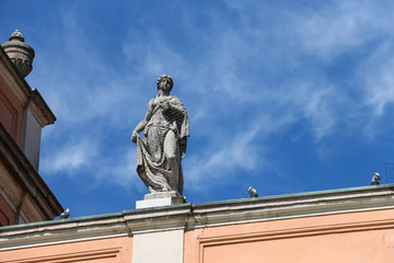 Antique statue on facade of Governor Palace in Piacenza, Italy