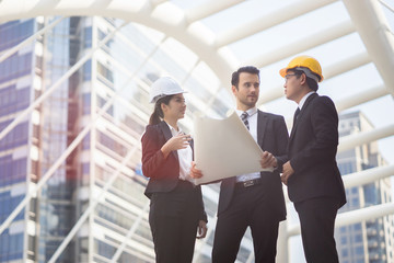 Engineering and architecture concept,engineers working on a building site holding a blueprints,architect man working  with engineer women inspection in workplace for architectural plan