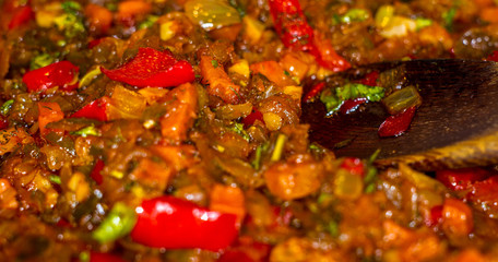 cooking a roast for soup of onions, carrots, paprika, tomatoes, herbs and spices in sunflower oil...