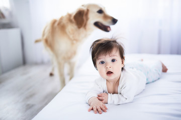 The small baby lies on the bed