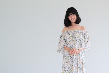 Fashion Portrait of Young  asian woman with short hair style wearing vintage Floral dress - copy space white background